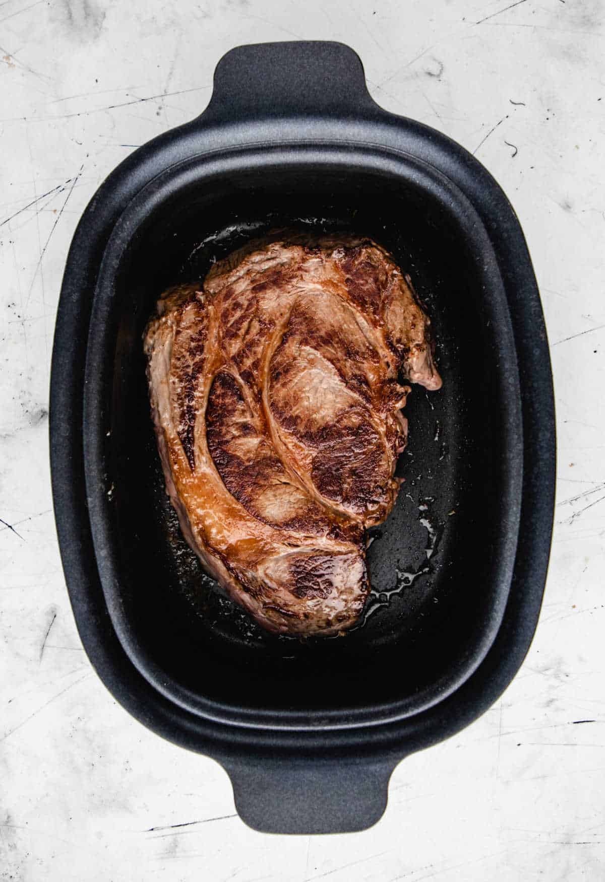 Browned chuck roast in a slow cooker. 