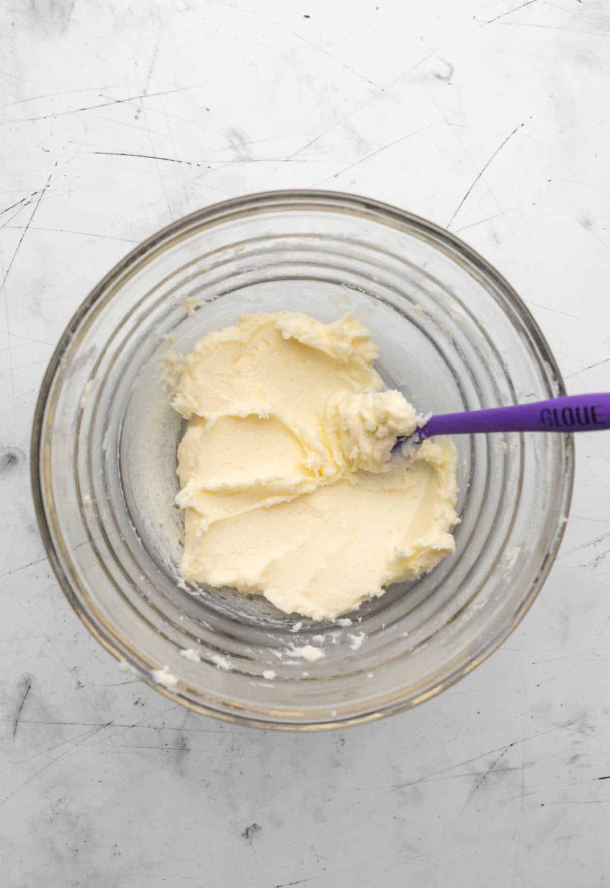 Creamed butter and sugar in a glass mixing bowl. 