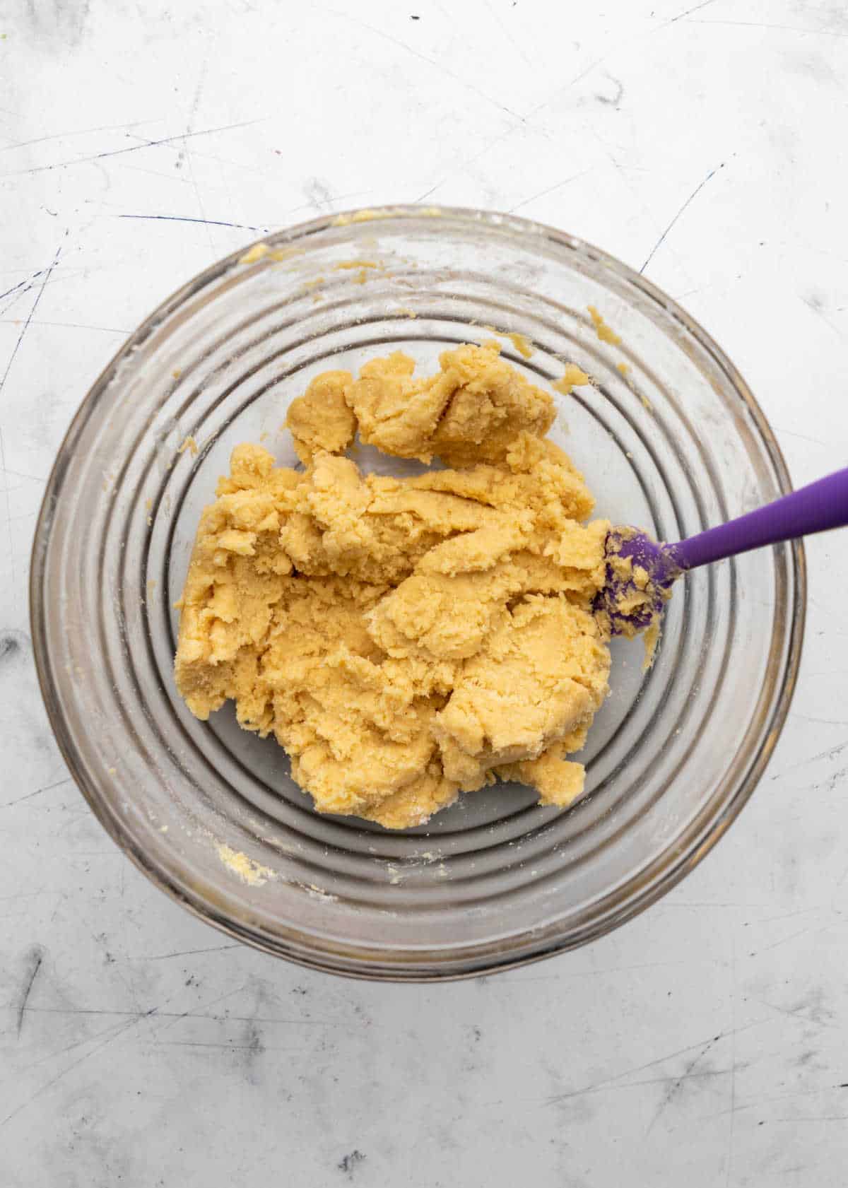 Spritz cookie dough in a glass mixing bowl. 