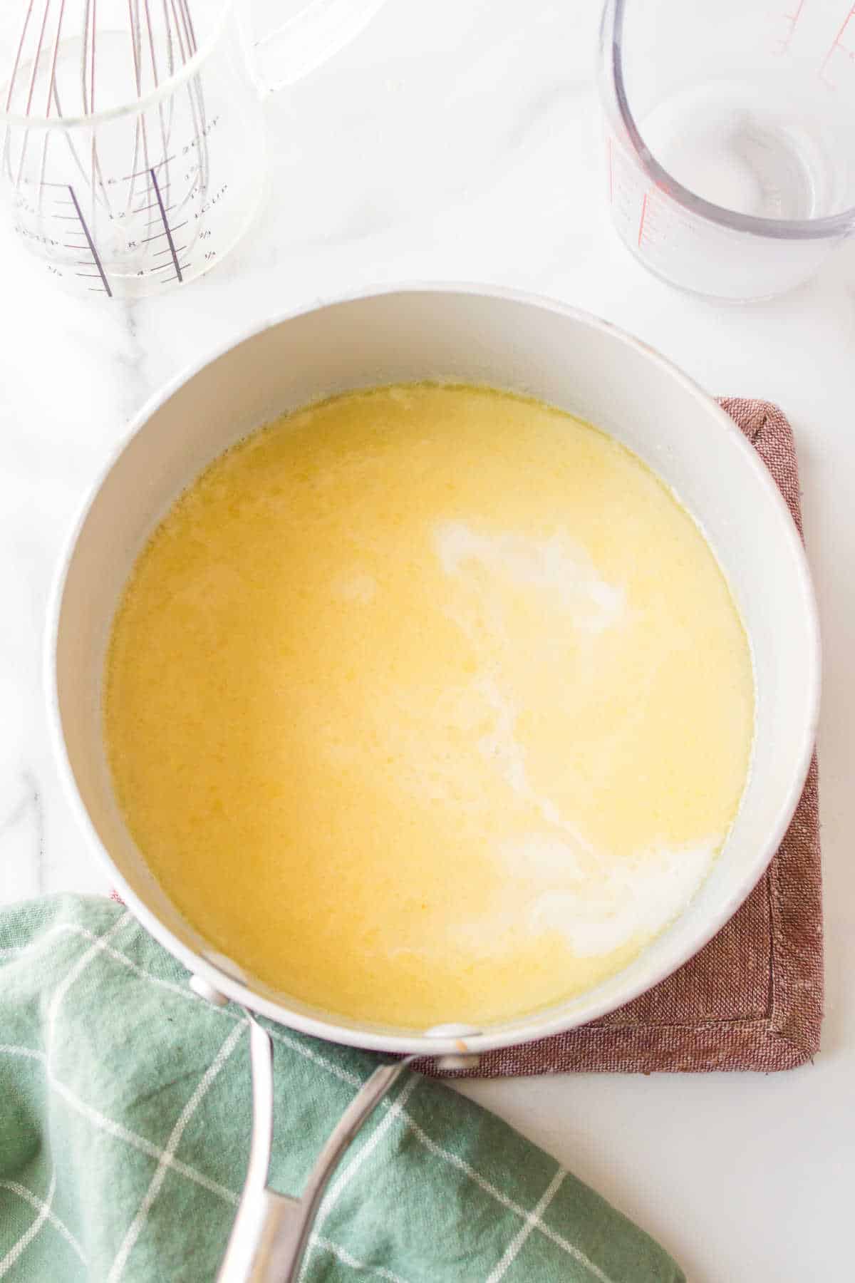 Chicken broth pouring in a milk flour mixture. 