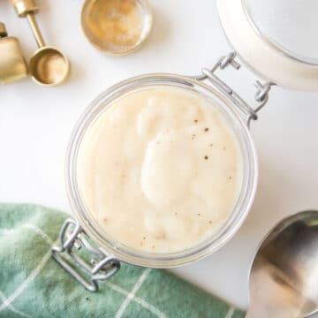 A glass jar of homemade cream of chicken soup.