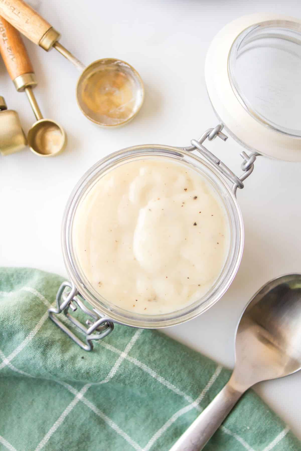 A glass jar of homemade cream of chicken soup.