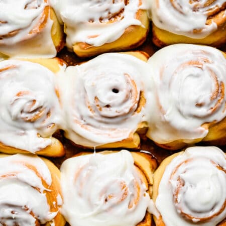 Frosted Honey Buns in a metal pan.