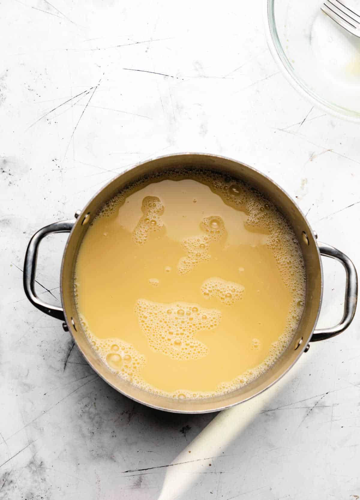 Chicken broth and lemon mixture in a stock pot.