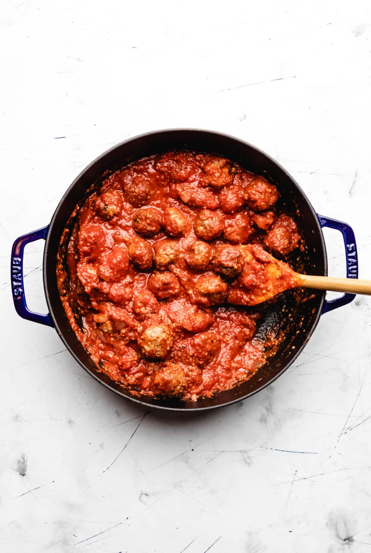 Baked meatballs in a cast iron skillet.