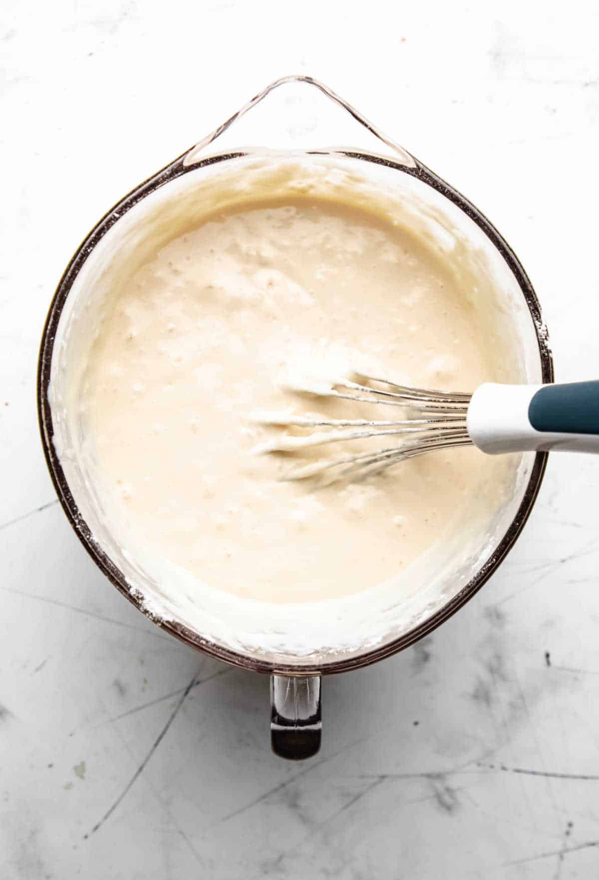 Buttermilk pancake batter in a glass mixing bowl.