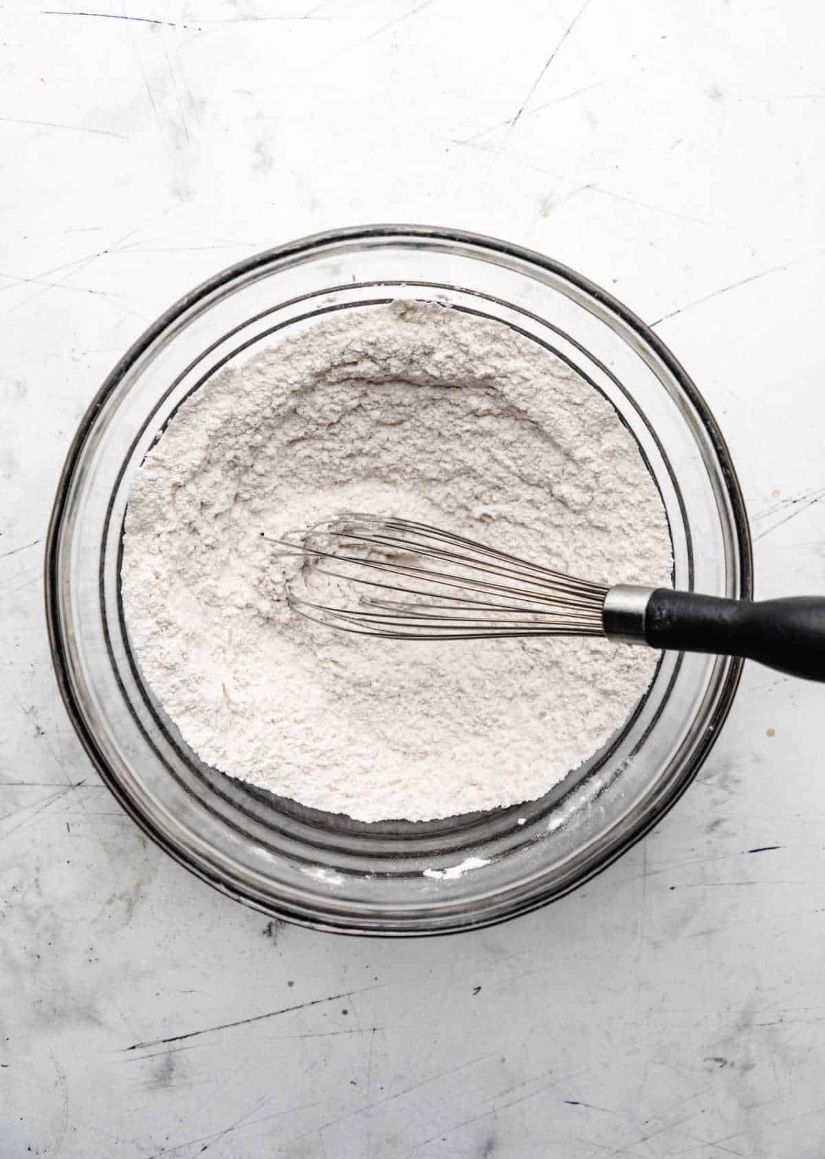 Dry ingredients for butter swim biscuits in a glass mixing bowl. 