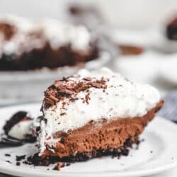 A slice of chocolate mousse pie on a white plate.