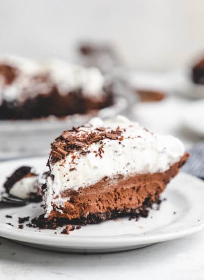 A slice of chocolate mousse pie on a white plate.