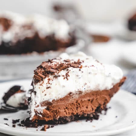 A slice of chocolate mousse pie on a white plate.