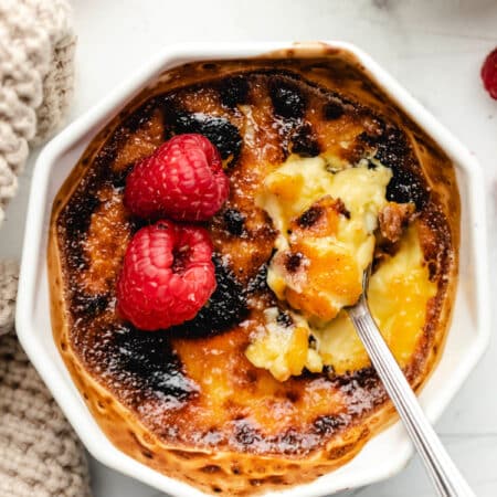 A silver spoon scooping up a bite of creme bruhlee.