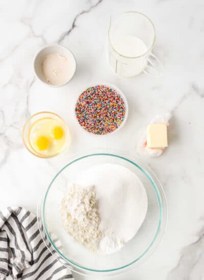 Ingredients for baked funfetti donuts in dishes.