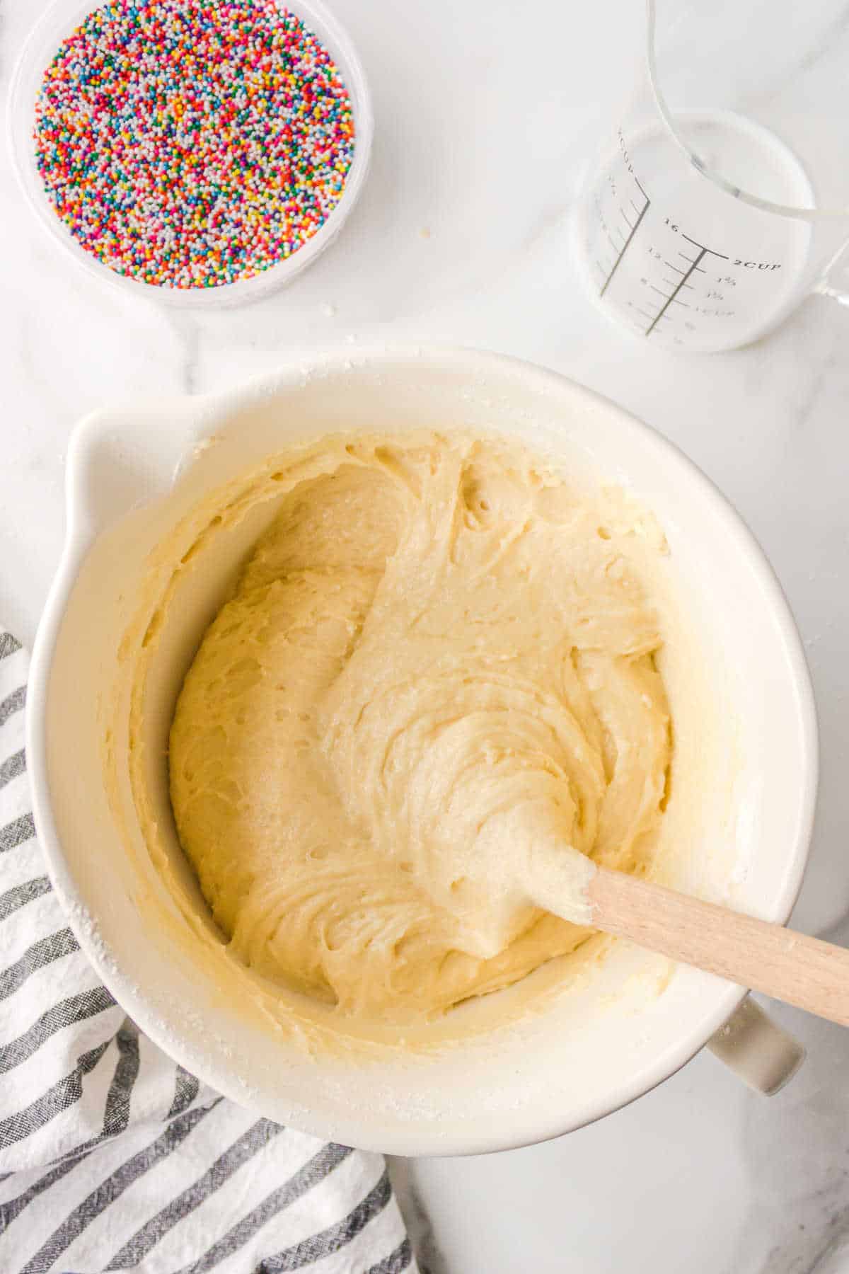 Funfetti donut batter in a mixing bowl. 