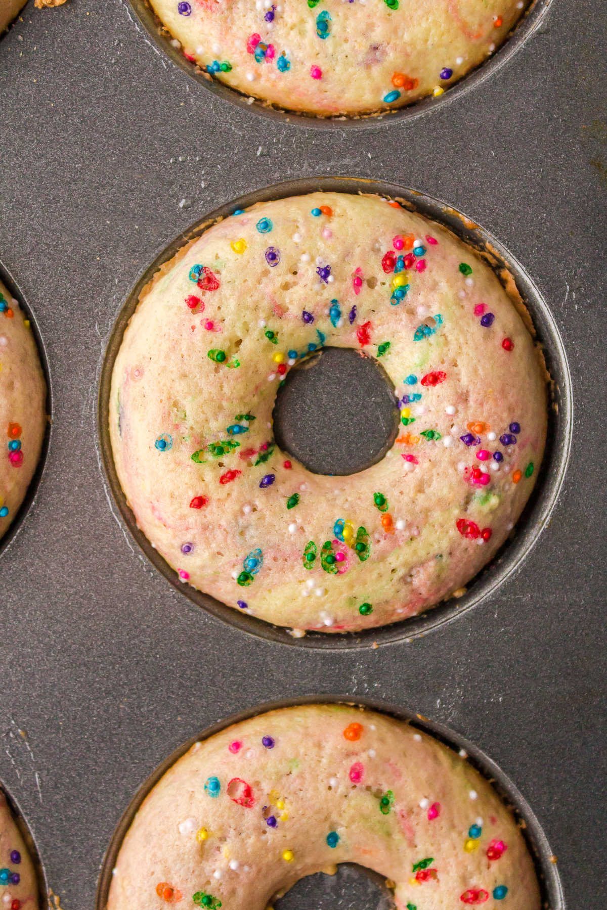 Baked funfetti donuts in a donut pan.