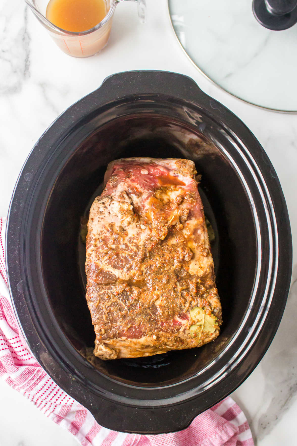 Brisket and marinade in a slow cooker. 