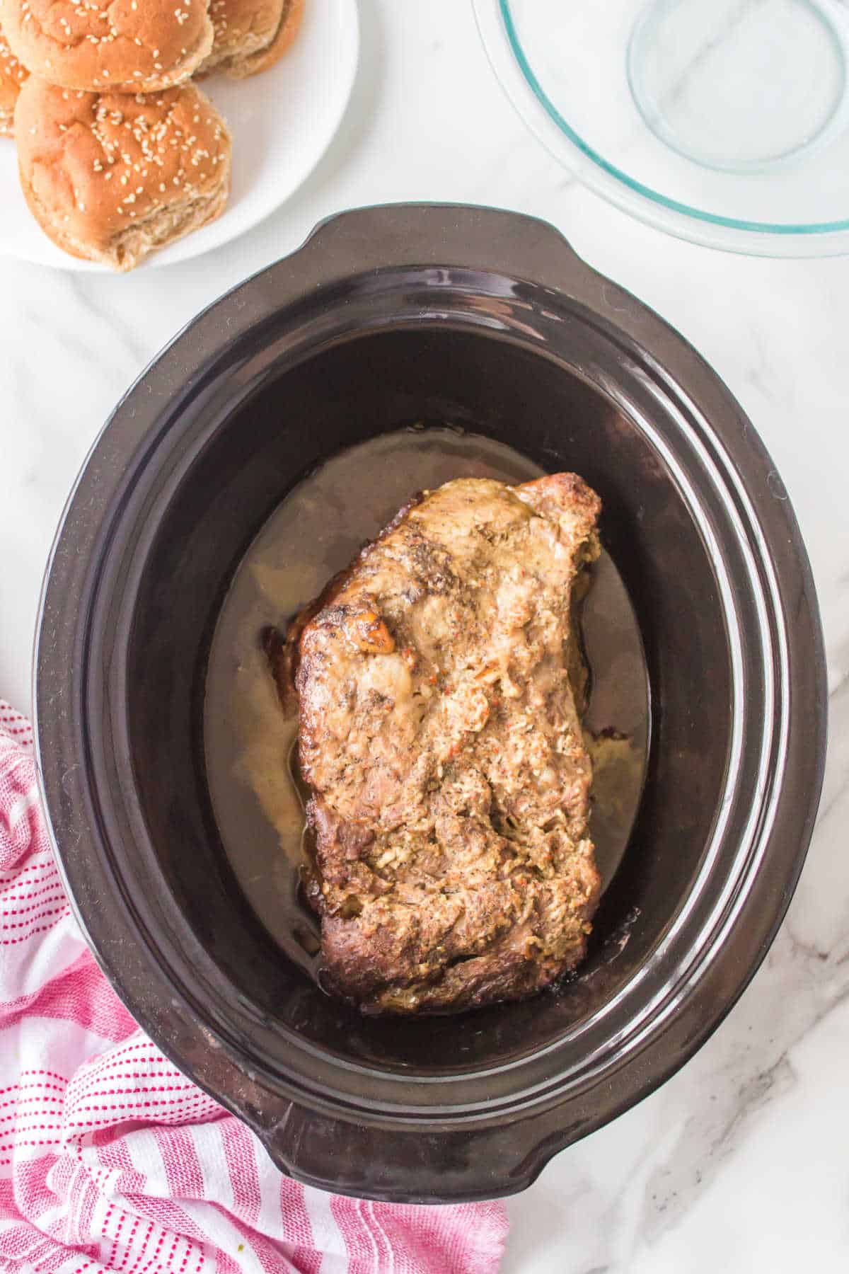 A cooked brisket in a slow cooker.