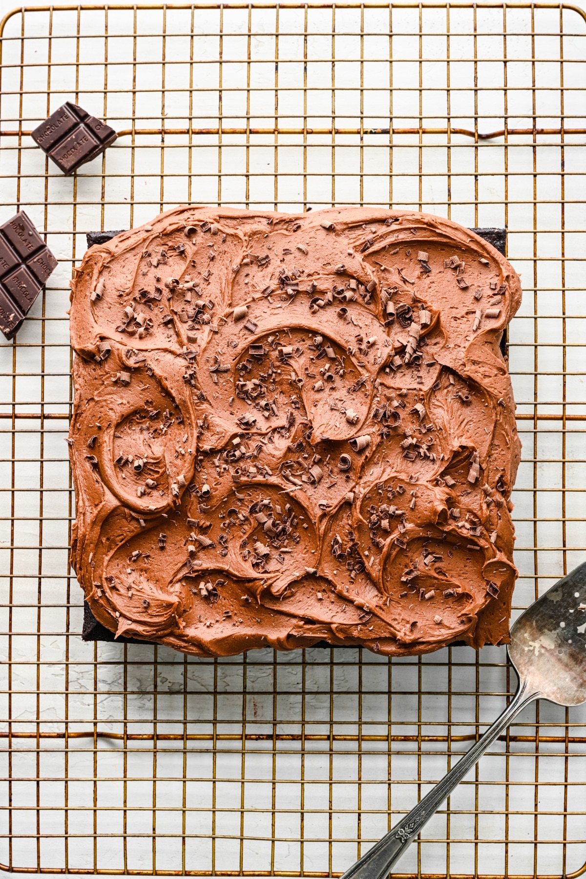 Frosted wacky cake on a wire cooling rack.