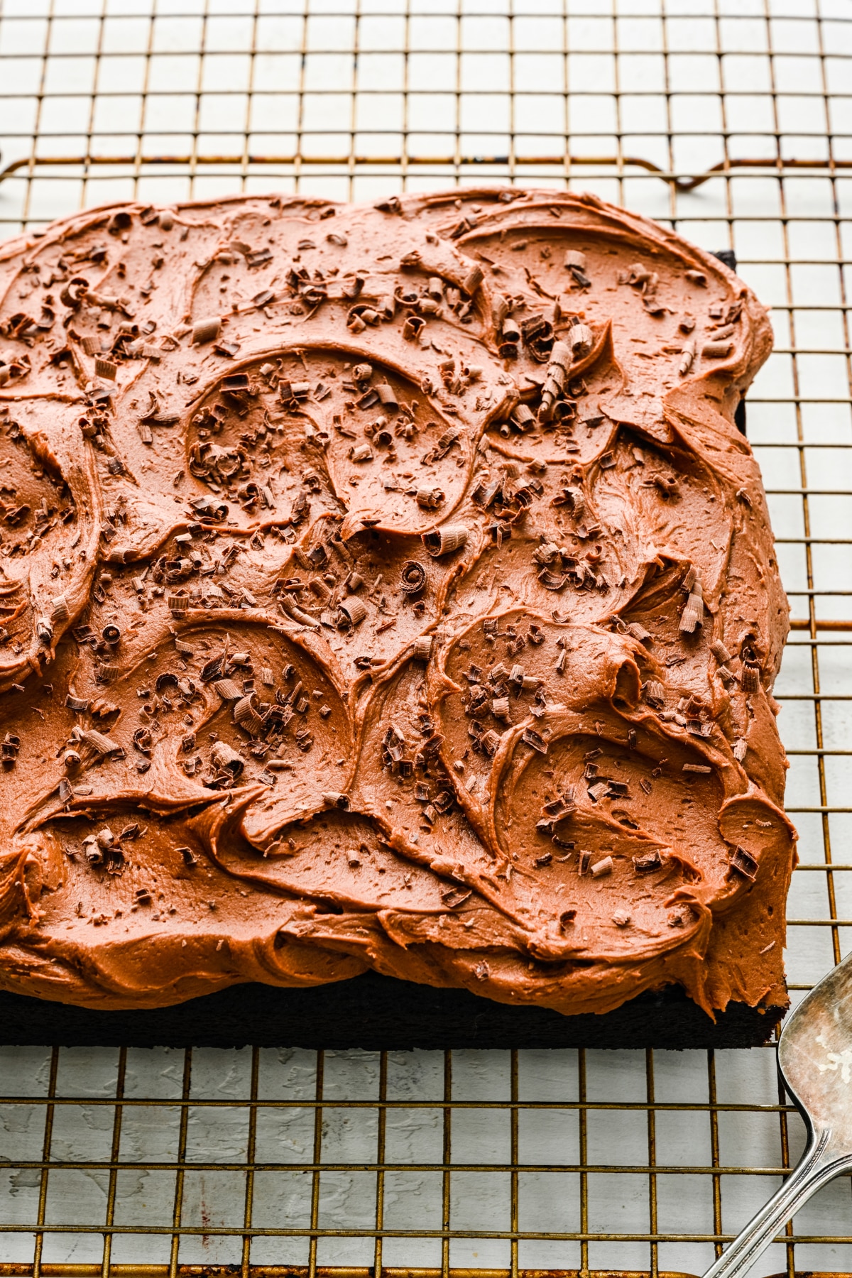 Chocolate wacky cake frosted with chocolate frosting and shaved chocolate.