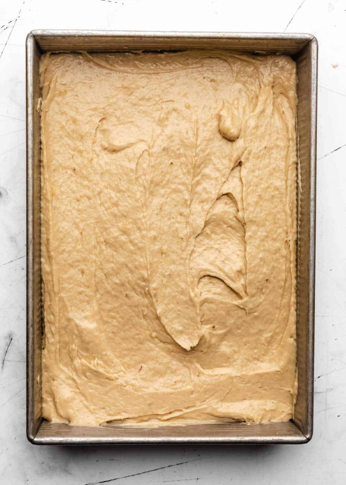 Banana cake batter in a baking pan.