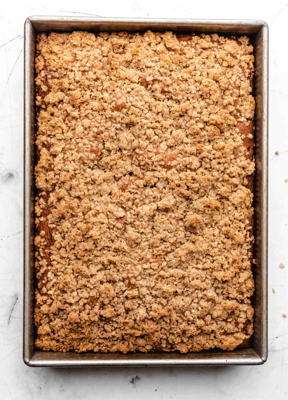 Baked banana crumb cake in a cake pan.