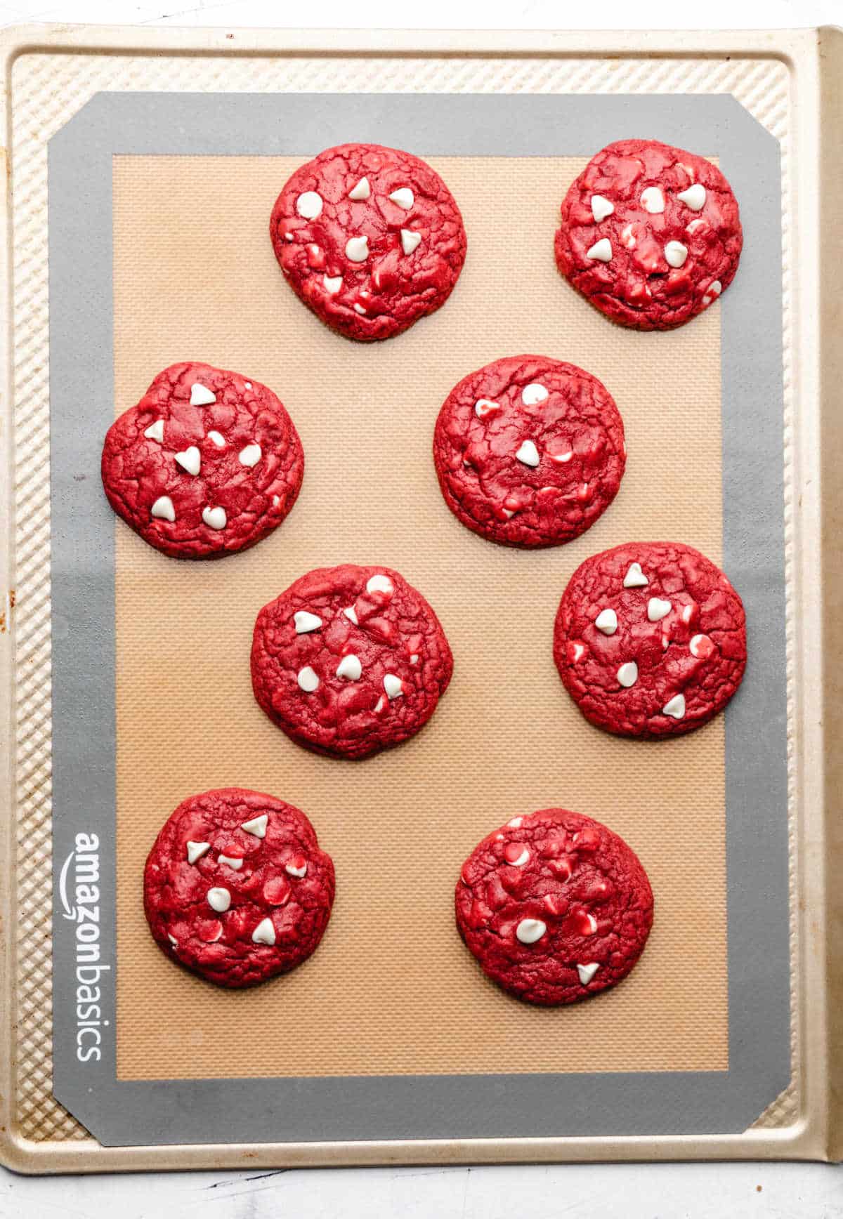 Baked red velvet cookies on a baking sheet.
