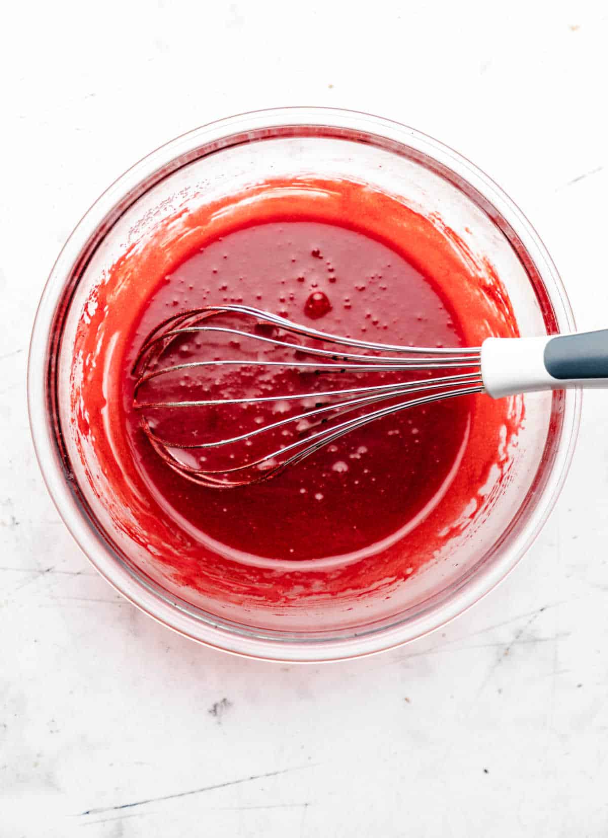 Red food coloring and vinegar mixed into butter mixture.