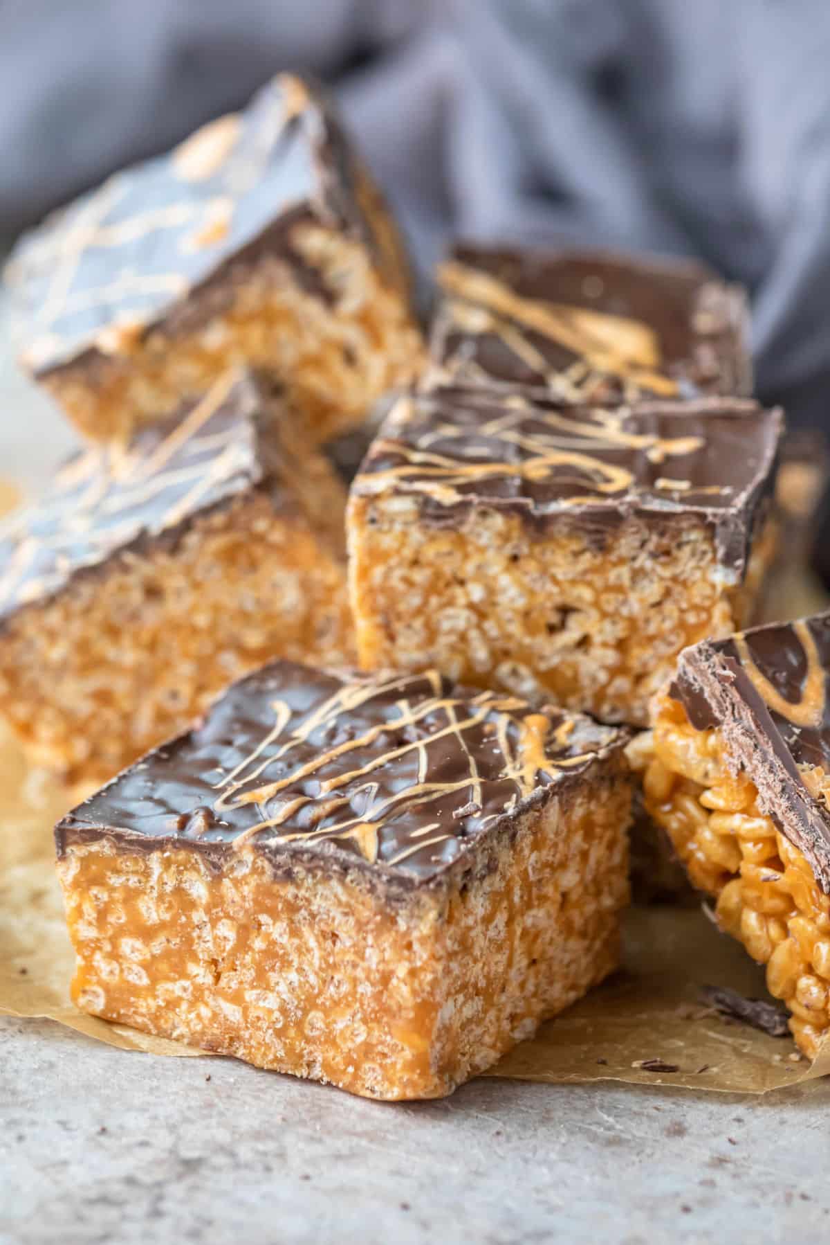 Stack of butterscotch rice krispies treats on a piece of brown parchment paper.