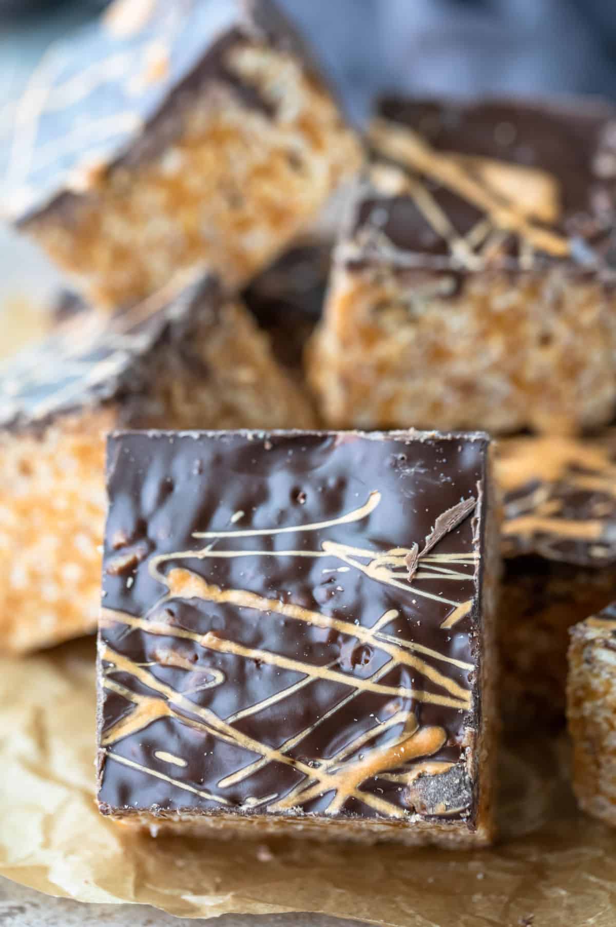 Butterscotch rice krispie treat set against a stack of treats. 