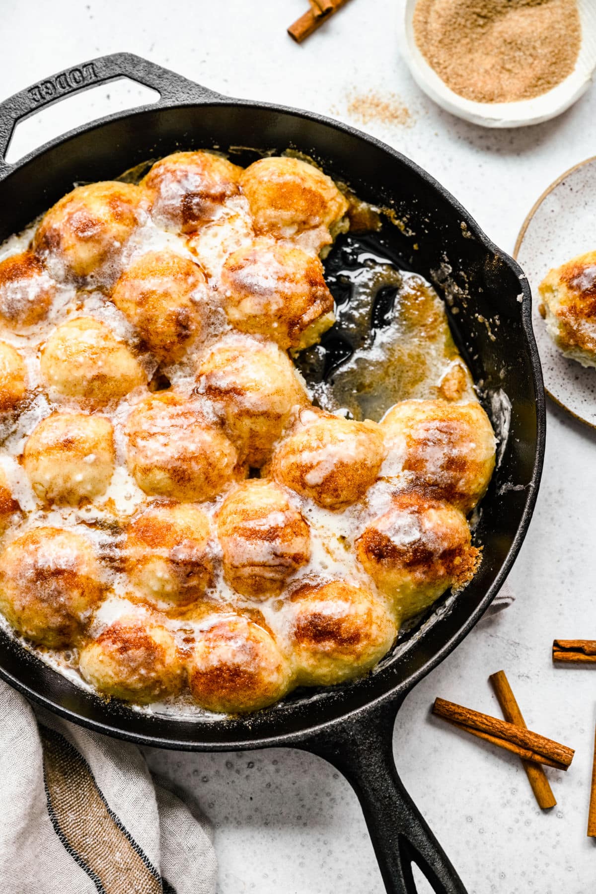 A pan of cinnamon roll bites with two missing. 