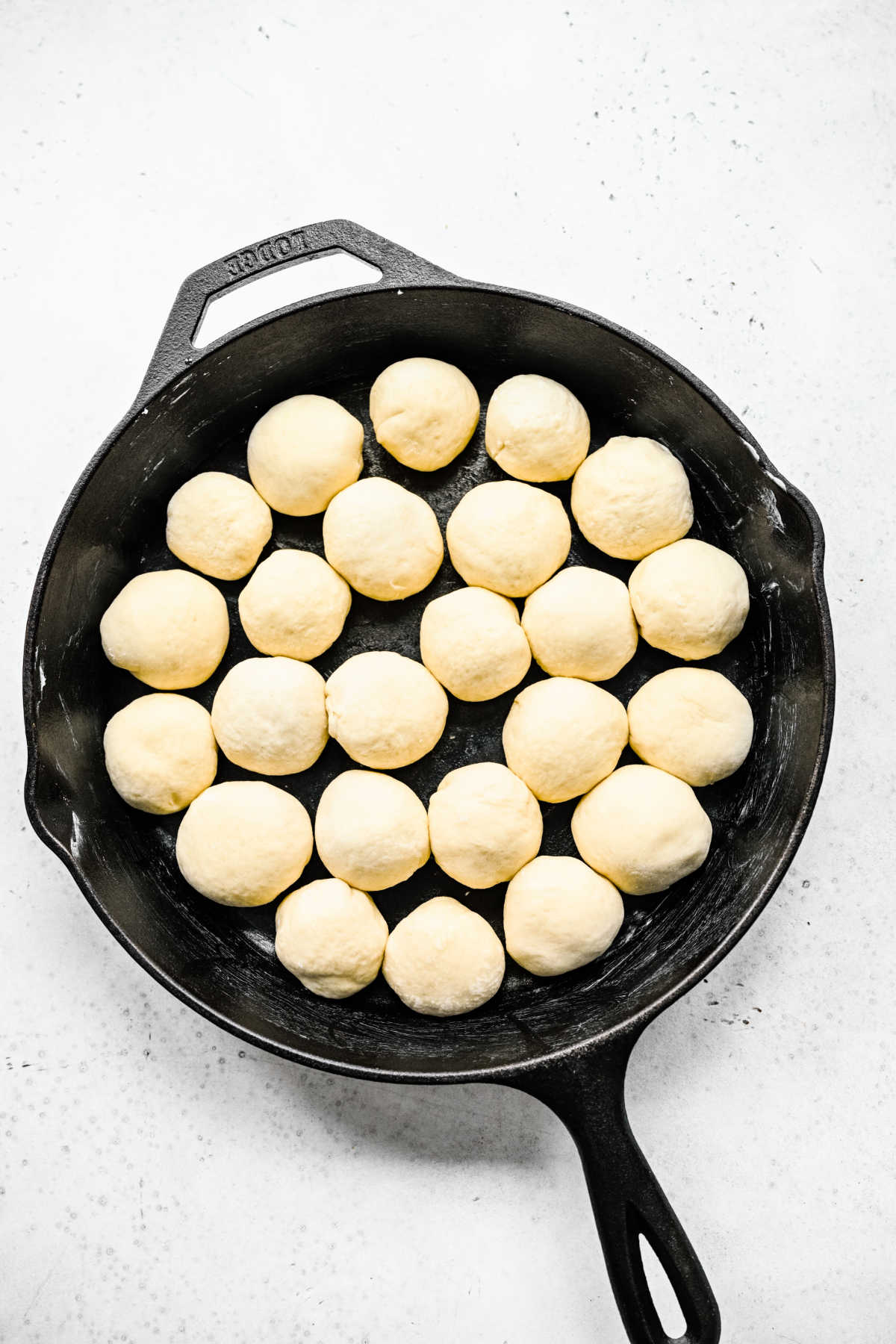 Cinnamon roll bite dough in a cast iron skillet. 