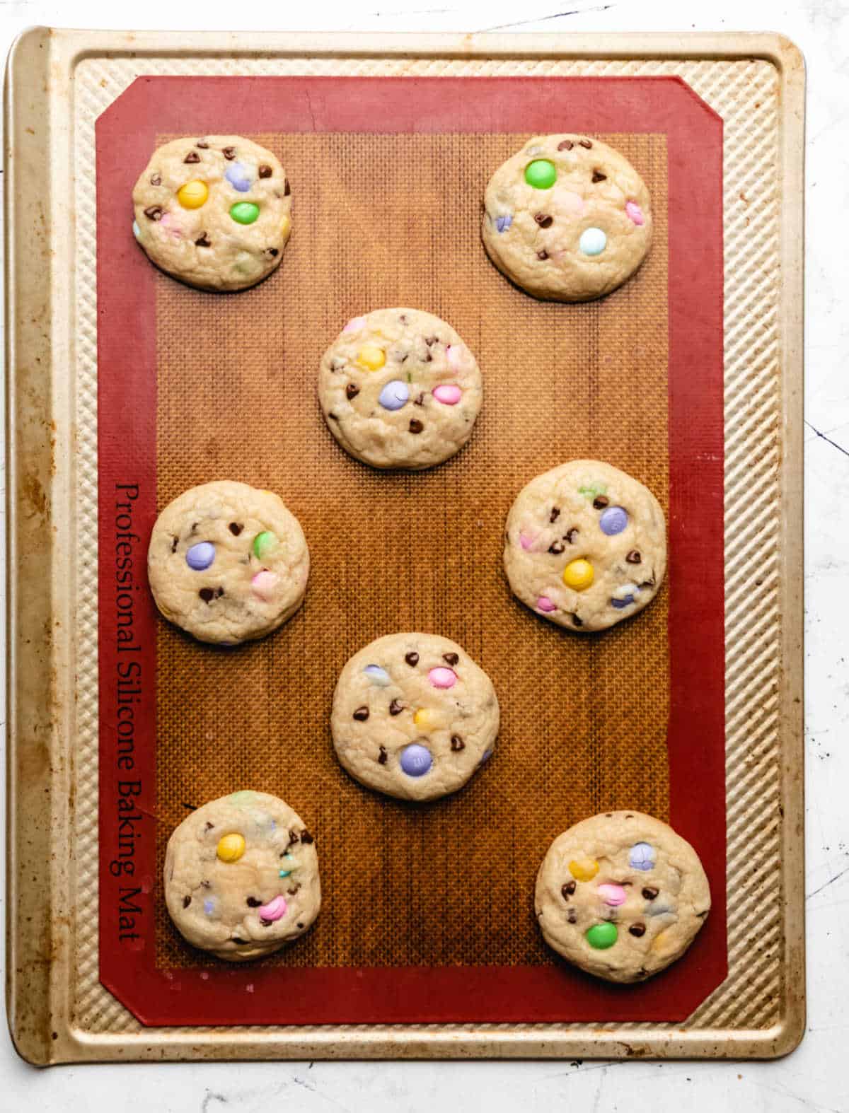 Baked Easter M&M cookies on a baking sheet. 