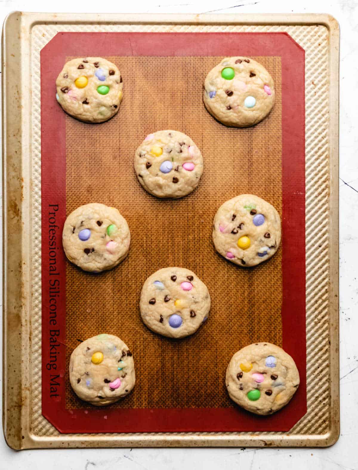 Baked Easter M&M cookies on a baking sheet.