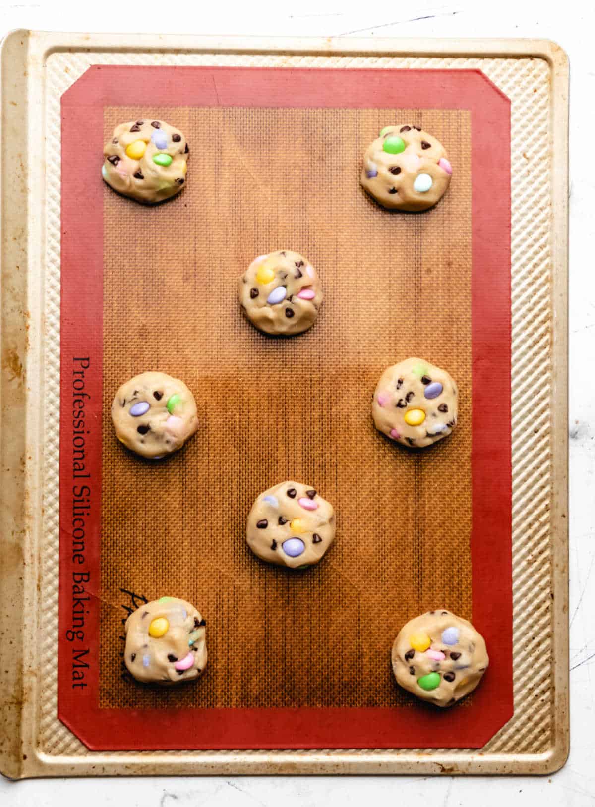 Easter M&M cookie dough on a baking sheet. 