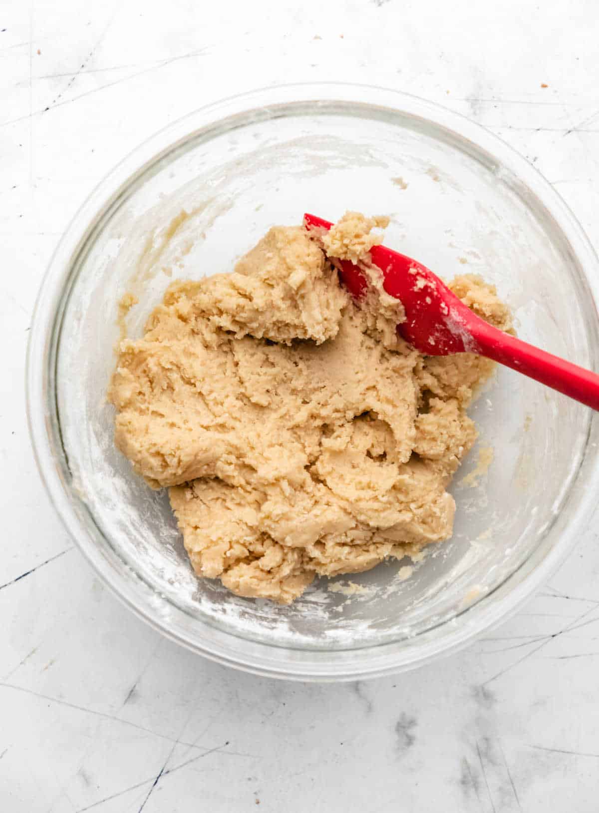 Cookie dough in a glass mixing bowl. 