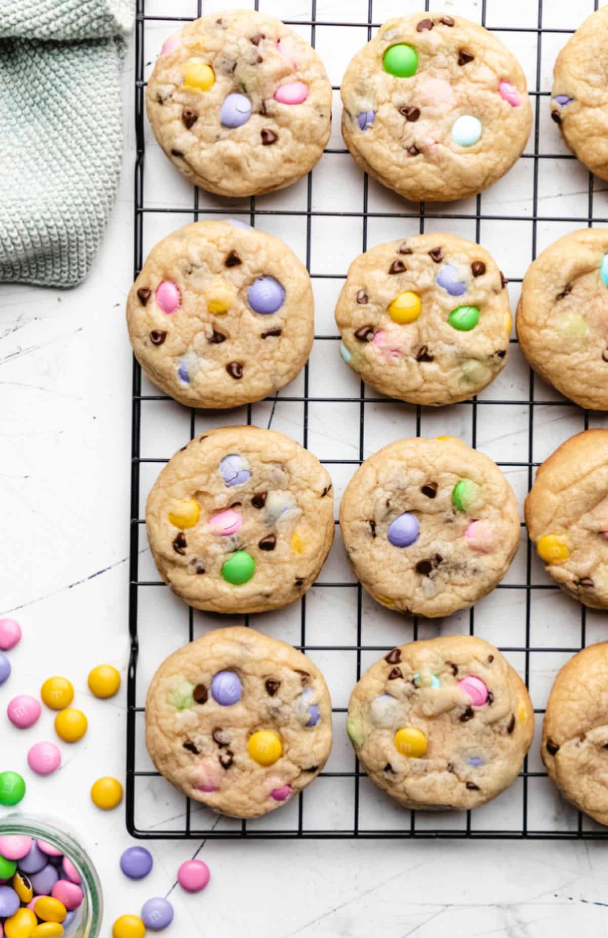 Rows of Easter M&M cookies on a wire cooling rack.