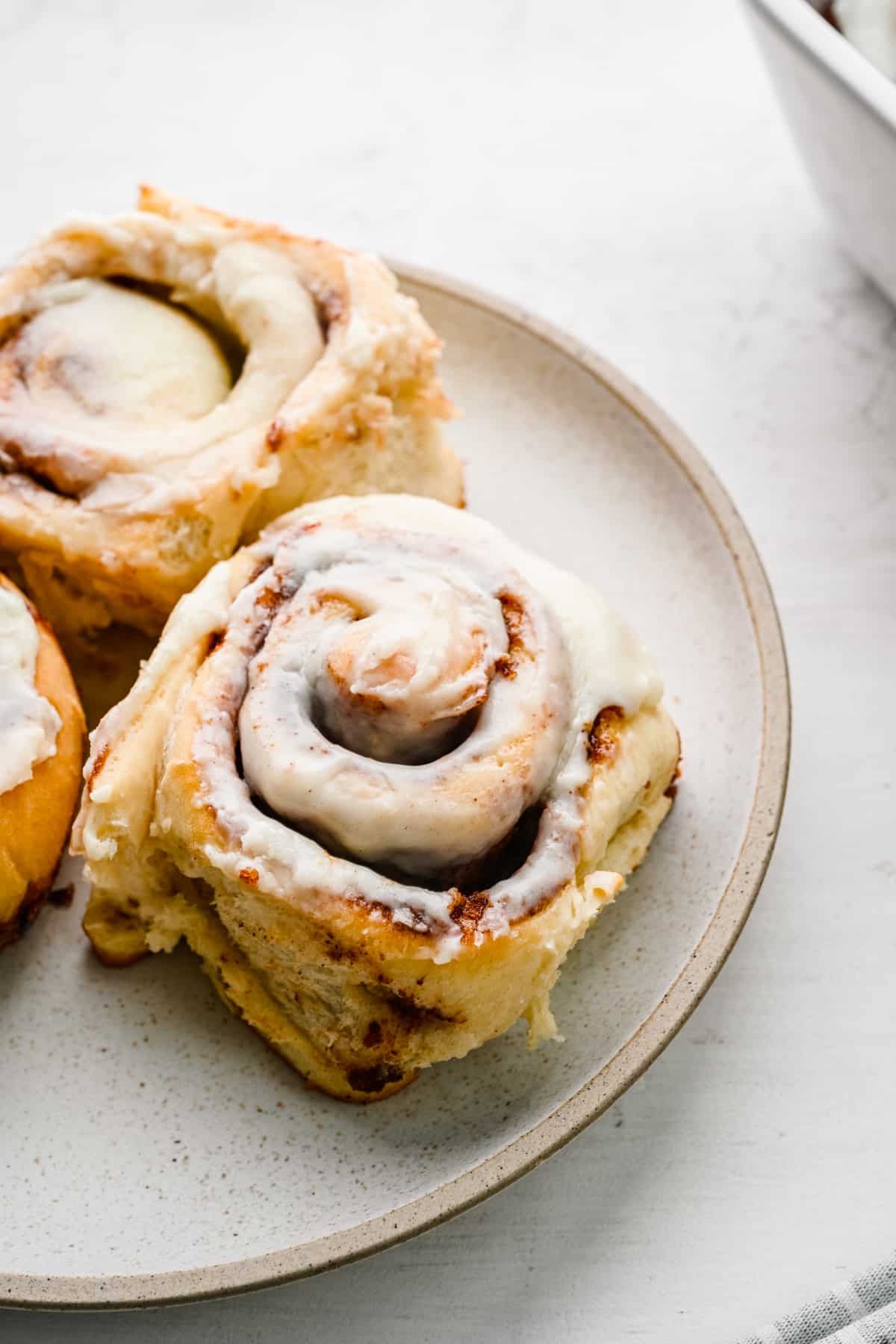 Easy homemade cinnamon rolls on a white plate. 