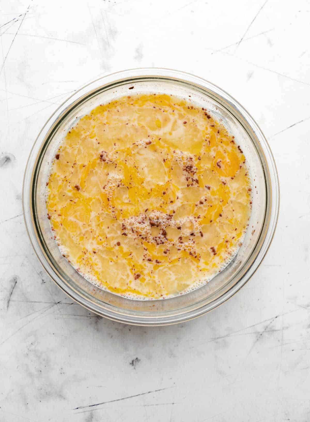 Egg mixture in a glass mixing bowl. 