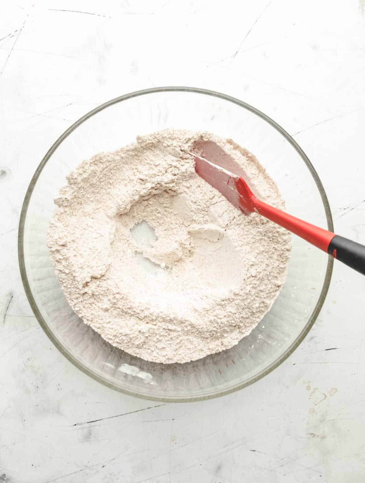 Irish brown soda bread dry ingredients with a well in the center. 