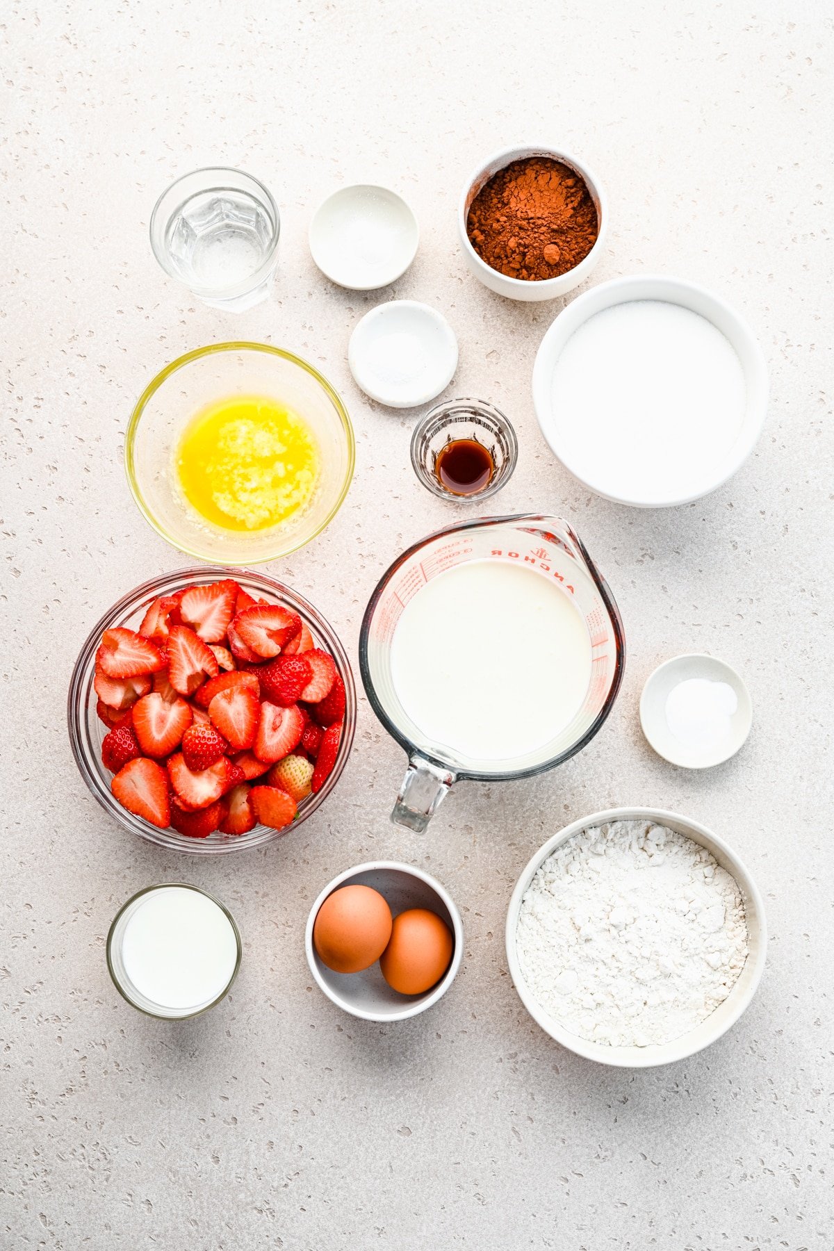 Ingredients for chocolate strawberry cake in dishes. 