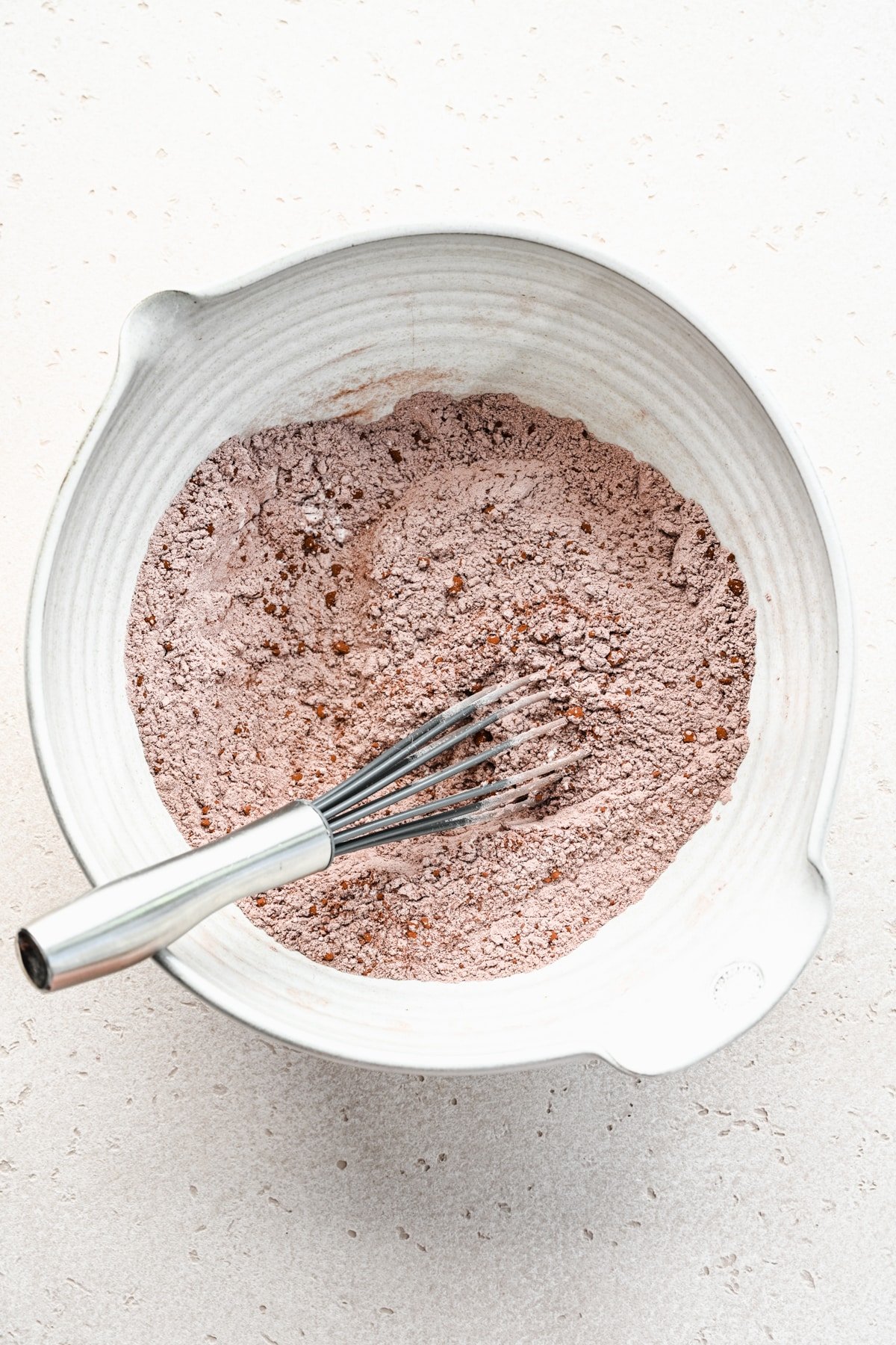 Dry ingredient mixture in a white mixing bowl. 