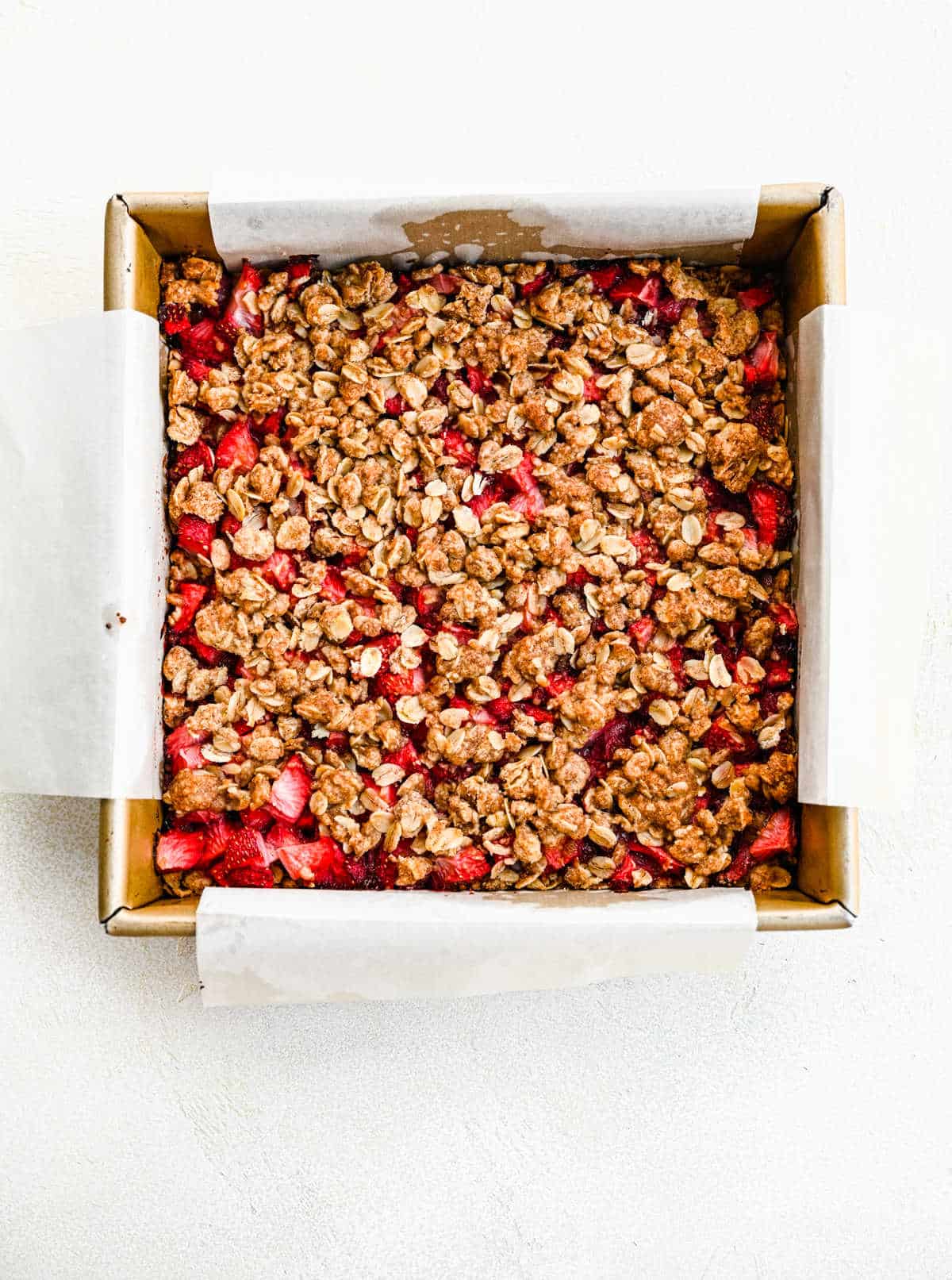 Baked strawberry oatmeal bars in a baking pan.