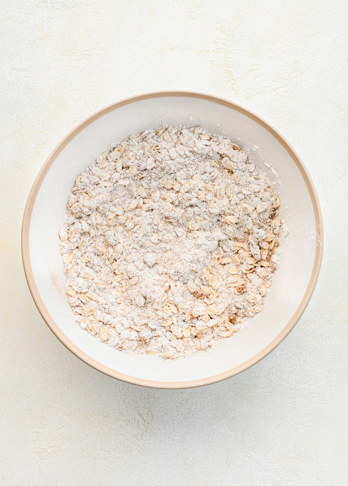 Dry ingredients for strawberry oatmeal bars mixed together in a mixing bowl.