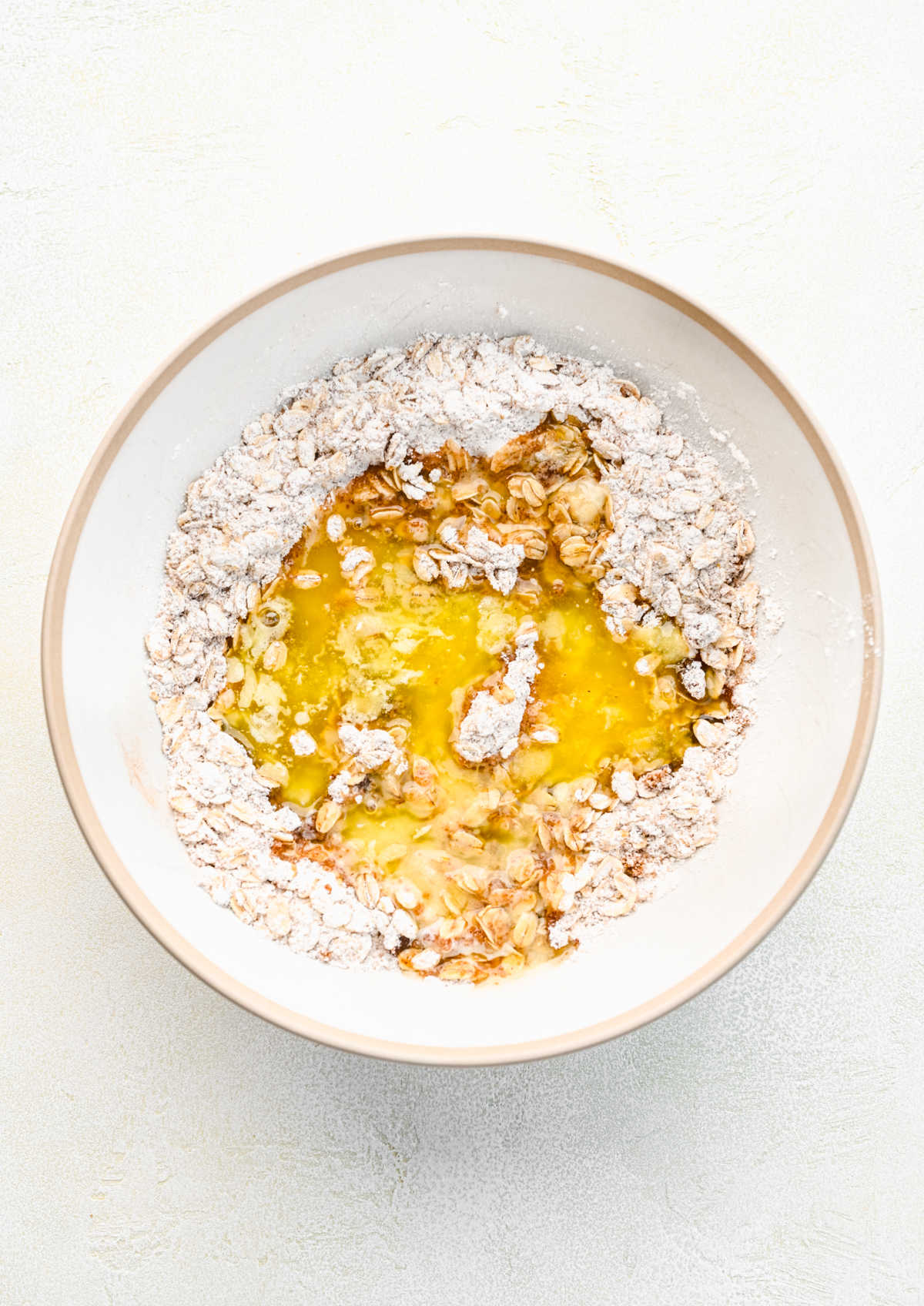 Melted butter in dry ingredients in a mixing bowl.