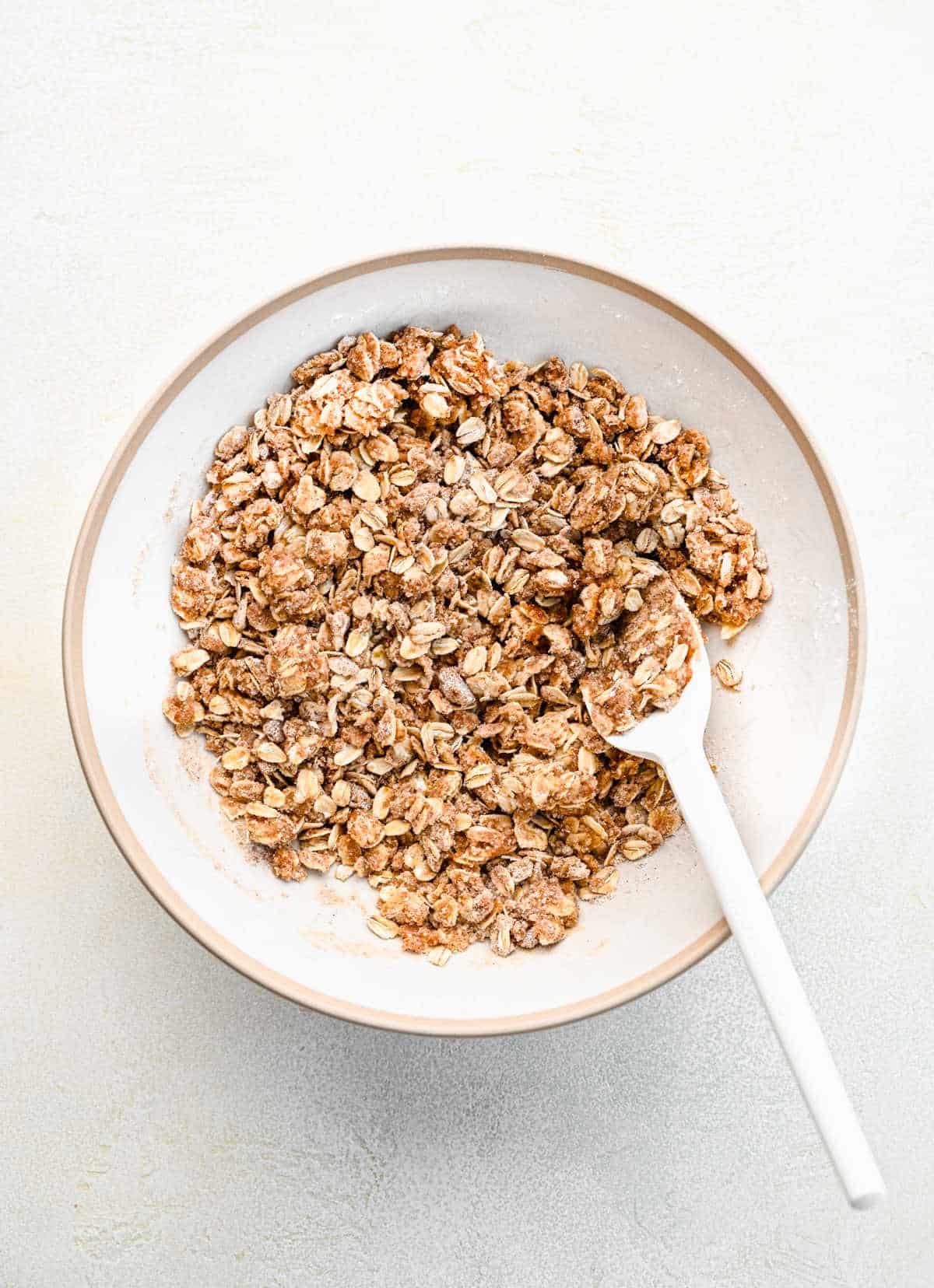 A bowl of crumble mixture for strawberry oatmeal bars. 