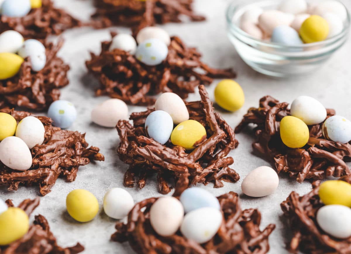 Bird's nest cookies surrounded by mini candy eggs. 