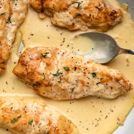 Three chicken breasts in creamy mustard sauce.