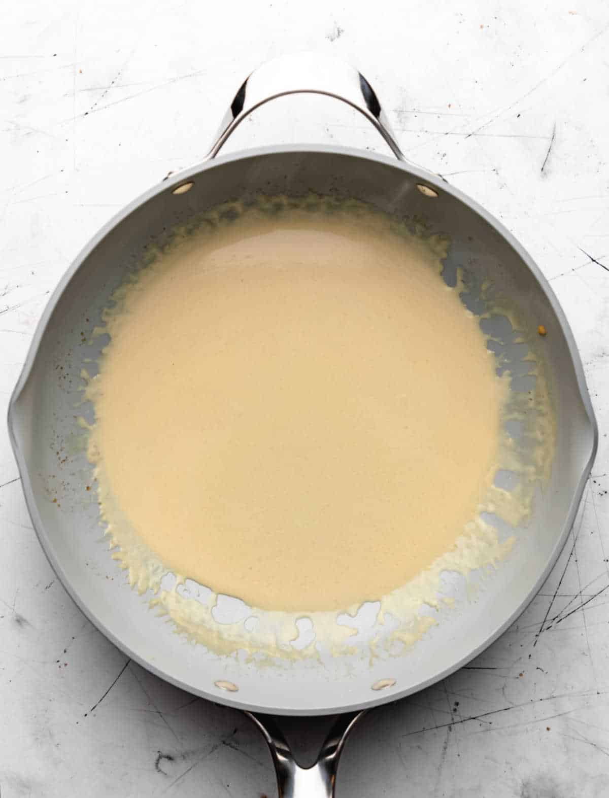 Creamy mustard sauce in a skillet. 