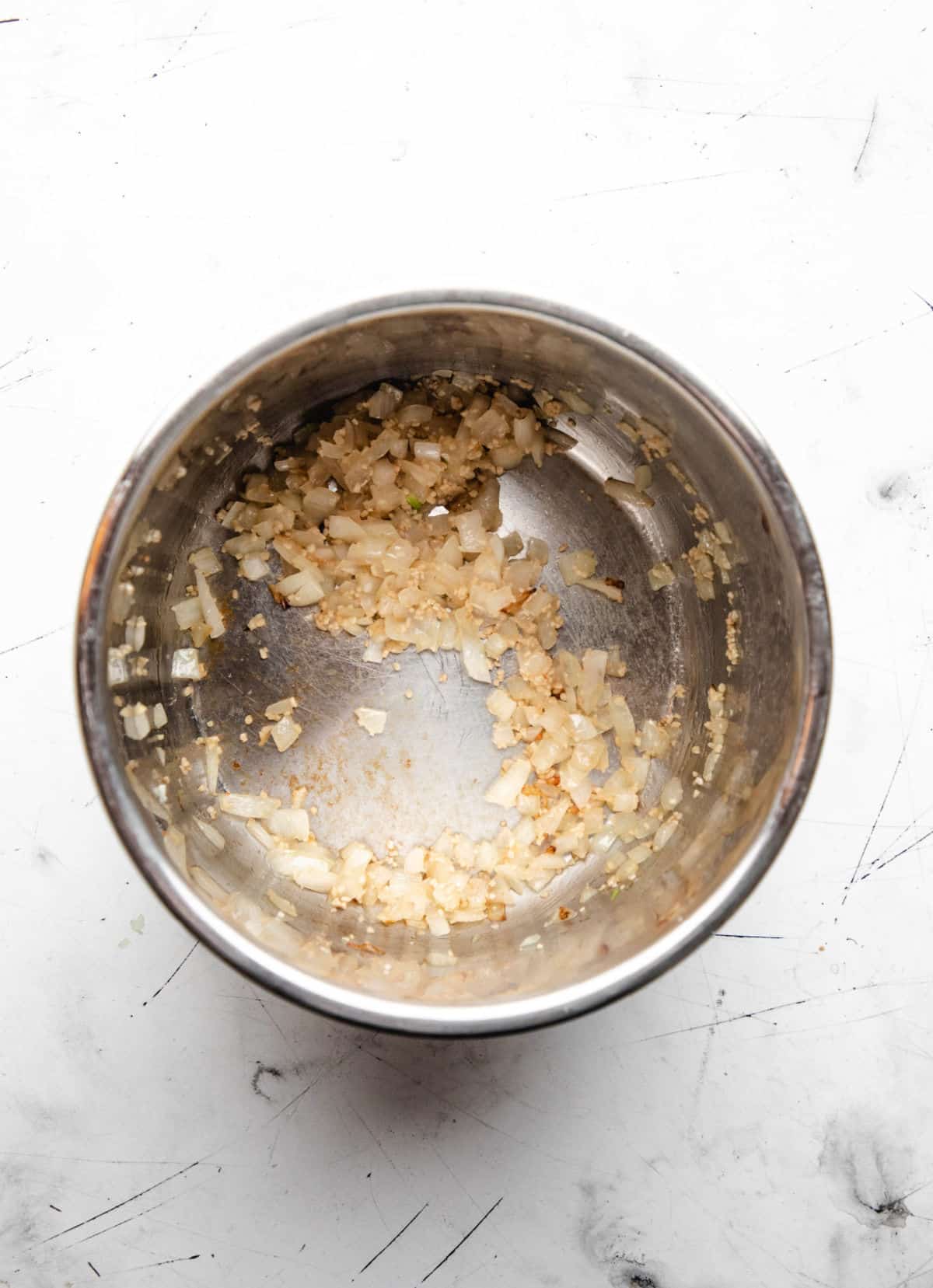 Onion and garlic sautéing in an instant pot.
