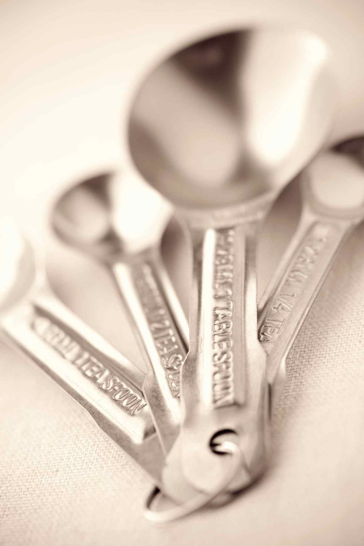 Close up photo of silver measuring spoons. 