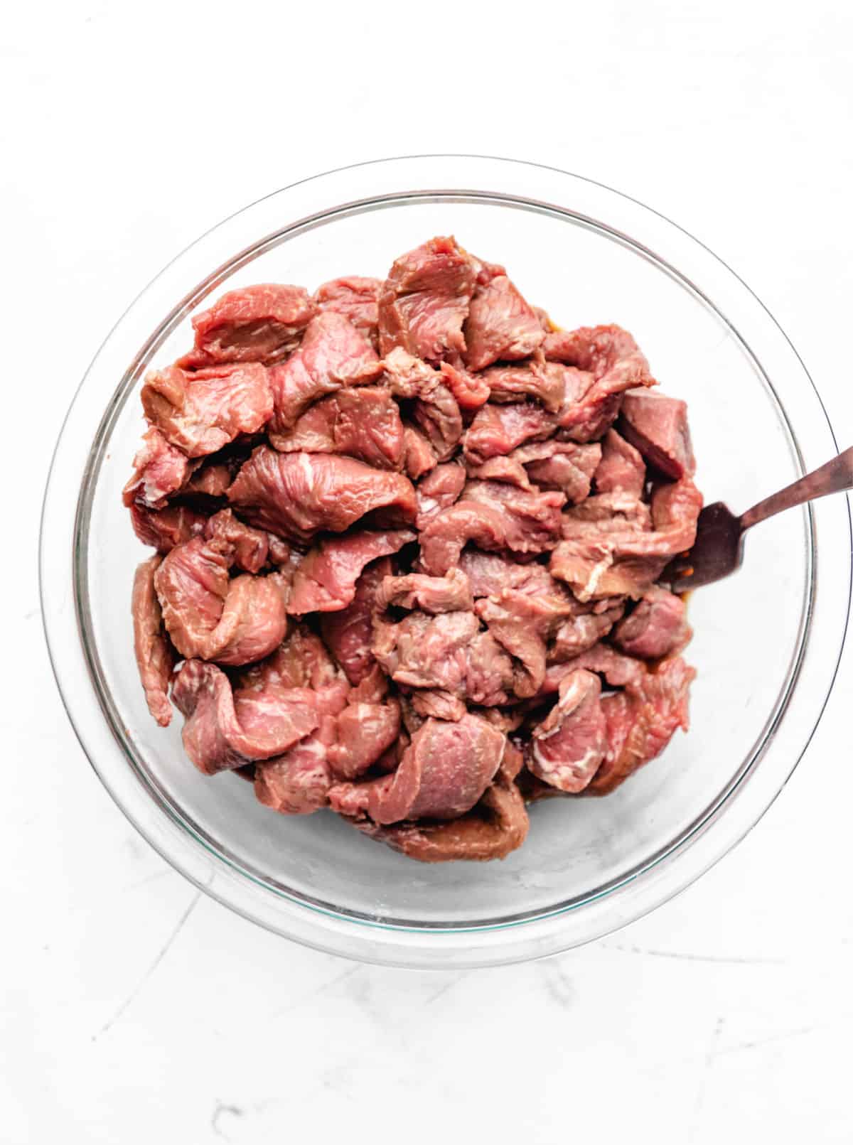 Sliced sirloin steak in soy sauce cornstarch mixture. 